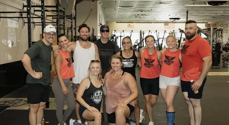 A large group of Ancient City CrossFit members gathered together on the gym floor after a workout.